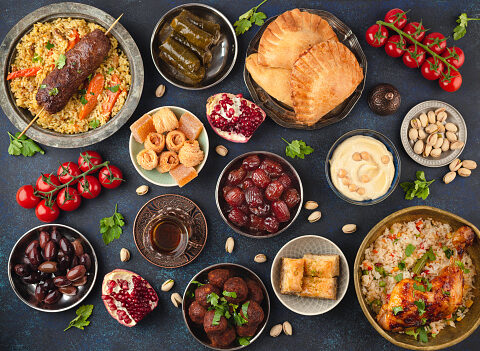 Ramadan kareem Iftar party table with assorted festive traditional Arab dishes, sweets, dates. Eid al-Fitr mubarak evening grand meal, top view. Islamic holidays food concept, Ramadan feast
